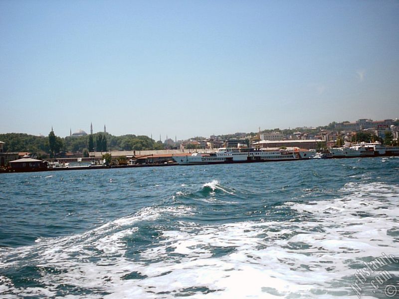 View of Eminonu coast, ships and Ayasofya Mosque (Hagia Sophia) from the sea in Istanbul city of Turkey.
