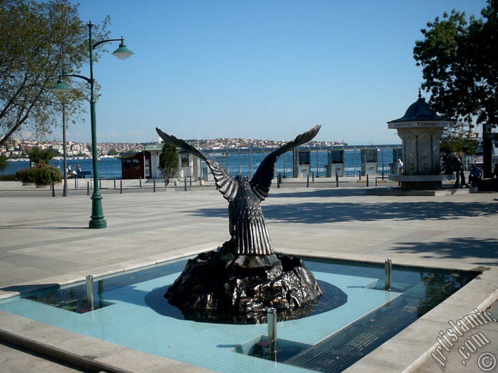 View of a park on the shore of Besiktas district and the coast of Uskudar on the horizon in Istanbul city of Turkey.
